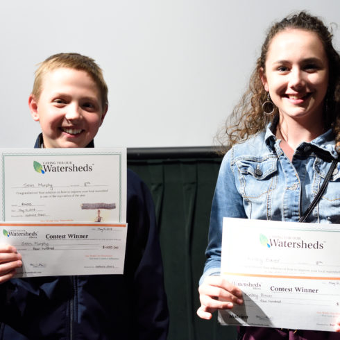 Two students proudly holding their Caring for our Watersheds certificates at the 2018 Final Competition